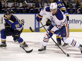 Edmonton Oilers' Nail Yakupov shoots as St. Louis Blues' Paul Stastny defends during NHL action Thursday, Oct. 8, 2015, in St. Louis.