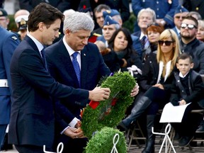 Prime minister-designate Justin Trudeau and Prime Minister Stephen Harper place a wreath during a ceremony Oct. 22, 2015 at the National War Memorial in Ottawa, marking the one-year anniversary of the attack on Parliament Hill.
