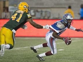 Edmonton Eskimos' Odell Willis tugs on the jersey of Montreal Alouettes' Rakeem Cato during a CFL game in Montreal on August 13, 2015. The Esks and Als renew their rivalry on  Sunday.