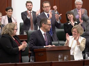 Finance Minister Joe Ceci receives applause after reading the NDP's 2015 Alberta budget at the Alberta legislature in Edmonton on Oct. 27, 2015.