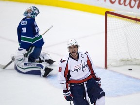 Washington Capitals' Alex Ovechkin, right, of Russia, celebrates after scoring what proved to be the game-winning goal against Vancouver Canucks' goalie Ryan Miller during the third period of an NHL hockey game in Vancouver, B.C., on Thursday October 22, 2015.