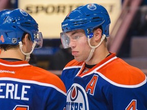 Jordan Eberle, left, and Taylor Hallof the Edmonton Oilers confer between play against the San Jose Sharks during an NHL game at Rexall Place on March.