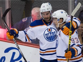 Edmonton Oilers' Teddy Purcell, left, and Ryan Nugent-Hopkins celebrate Nugent-Hopkins' goal against the Vancouver Canucks during the third period of a pre-season game in Vancouver on Saturday Oct. 3, 2015.