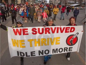 First Nations people march down Jasper Avenue in the ceremonial Walk of Reconciliation from the Shaw Conference Centre to the Legislature after the close of the Truth and Reconciliation Commission in Edmonton on Sunday, March 30, 2014.