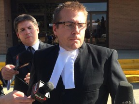 Crown prosecutor Ryan Pollard speaks outside the Wetaskiwin courthouse Friday after arguing a youth should be sentenced as an adult for the murder of a care worker.
