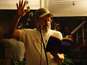 Comedian/actor David Cross reads from Eve Ensler's Vagina Monologues at a private house party in Edmonton on Saturday night. With musical guest Ted Leo, left.