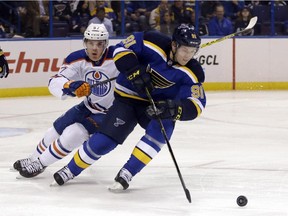 St. Louis Blues' Vladimir Tarasenko, right, controls the puck as Edmonton Oilers' Connor McDavid, left, pursues during the first period. Oct. 8, 2015, in St. Louis.