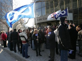 In this April 3, 2006 file photo, members of the Manitoba Métis community take part in a procession to the Manitoba Law Courts in Winnipeg to pursue court action against that province on land ownership issues.