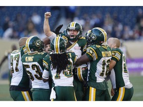 Edmonton Eskimos' Sean Whyte, centre, and his teammates celebrate Whyte's last-second game-winning field goal against the Winnipeg Blue Bombers in Winnipeg on Saturday, Oct. 3, 2015.