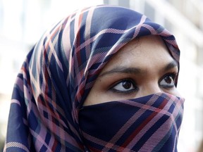 Zunera Ishaq talks to reporters outside the Federal Court of Appeal after her case was heard on whether she can wear a niqab while taking her citizenship oath, in Ottawa on Sept. 15, 2015. The federal government says it plans to challenge the decision that quashed its attempts to ban face coverings at citizenship ceremonies.