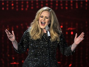 FILE - In this Feb. 24, 2013 file photo, Adele performs during the Oscars at the Dolby Theatre in Los Angeles. Adele's "Hello" single has become the first song to sell one million tracks in a week. Her comeback track sold 1.11 million digital songs, setting a new record. Her complete album "25," will be released on Nov. 20.