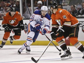 Edmonton Oilers centre Anton Lander skates his way up the ice as Anaheim Ducks' Cam Fowler defends during the first period on Nov. 11, 2015, in Anaheim, Calif.