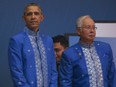 U.S. President Barack Obama, left, stands next to Malaysian Prime Minister Najib Razak during the gala dinner of the ASEAN Summit in Kuala Lumpur, Malaysia on Saturday, Nov. 21, 2015.