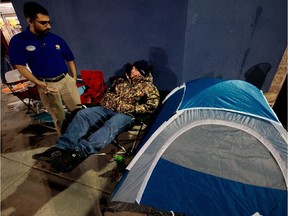 Store manager Asad R. Ali, left, goes over the ground rules of sidewalk camping with Brent Hart, 26, in advance of Black Friday outside the Fair Lakes Best Buy store in Fairfax, Va. This photo was taken on Nov. 23, 2011.