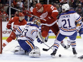 Detroit Red Wings defenceman Mike Green (25) screens Edmonton Oilers goalie Cam Talbot (33) before Detroit Red Wings centre Gustav Nyquist (14) of Sweden scores during the second period of an NHL hockey game, Friday, Nov. 27, 2015, in Detroit. The Wings won 4-3 in overtime.