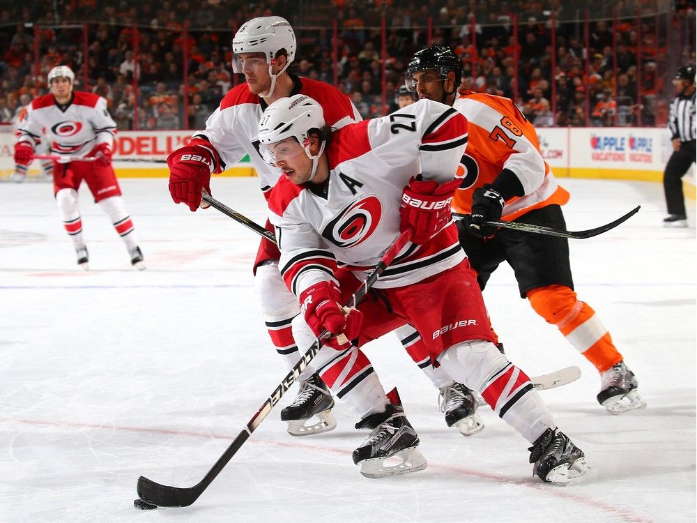 Justin Faulk (27) of the Carolina Hurricanes takes the puck in the second period as Pierre-Edouard Bellemare (78) of the Philadelphia Flyers defends on Nov. 23, 2015 at the Wells Fargo Center in Philadelphia, Penn.