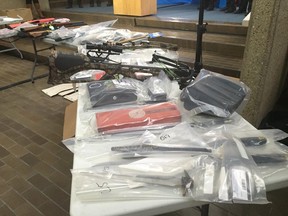 Edmonton police have charged 78 people with more than 400 offences after a drug investigation. Guns, a crossbow and knives are on display at EPS headquarters on Nov. 5, 2015.