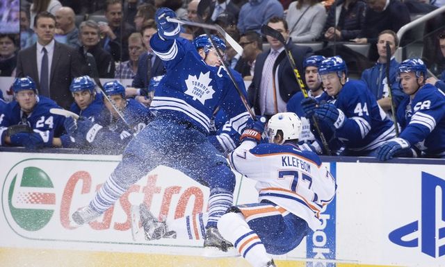 Toronto Maple Leafs' Dion Phaneuf, left, and Edmonton Oilers' Oscar Klefbom collide during first period NHL hockey action in Toronto on Monday, November 30, 2015.