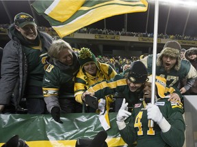 Edmonton Eskimos defensive end Odell Willis celebrates with fans after defeating the Calgary Stampeders in the CFL's West Division final on Nov. 22, 2015, at Commonwealth Stadium.