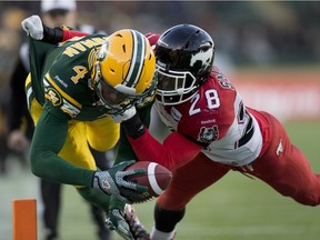 Edmonton Eskimos Adarius Bowman (4) dives into the end zone with Calgary Stampeders Brandon Smith (28) on him during first half CFL Western Final action on November 22, 2015 in Edmonton. The Eskimos are heading to the Grey Cup after defeating Calgary by a score of 45-31.