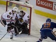Edmonton Oilers' Leon Draisaitl watches the puck bounce off the post on Chicago Blackhawks goalie Corey Crawford  and Trevor van Riemsdyk during the first period on Nov. 18, 2015, in Edmonton. The Hawks beat the Oilers 4-3 in overtime.