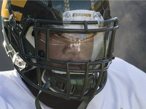 The stadium is reflected in the face mask of Slotback Kendial Lawrence during Edmonton Eskimos practice at Commonwealth Stadium on Nov. 18, 2015.