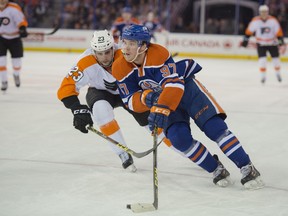 Connor McDavid of the Edmonton Oilers, charges the net chased by Brandon Manning of the Philadelphia Flyers at Rexall Place. McDavid, injured in the second period, will be out for months.