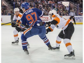 EDMONTON, AB. NOVEMBER 3,  2015 -Connor McDavid   of the Edmonton Oilers, catches an edge with his left skate while being checked by Brandon Manning of the Philadelphia Flyers at Rexall Place in Edmonton. McDavid broke his collarbone in the fall and ensuing collision with the boards. Shaughn Butts/Edmonton Journal