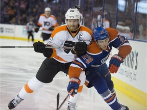 Leon Draisaitl of the Edmonton Oilers, challenges Claude Giroux of the Philadelphia Flyers at Rexall Place in Edmonton.