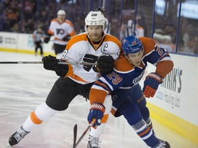 Leon Draisaitl of the Edmonton Oilers challenges Claude Giroux of the Philadelphia Flyers at Rexall Place in Edmonton on Tuesday, Nov. 3, 2015.