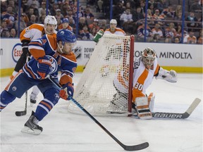 Taylor Hall of the Edmonton Oilers, tries to wrap around on Michal Neuvirth of the Philadelphia Flyers at Rexall Place in Edmonton.