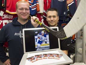 Upper Deck rep Chris Carlin (left) and  Wayne's Sports Cards store owner Wayne Wagner prepare for the  release Thursday of the Connor McDavid rookie card.