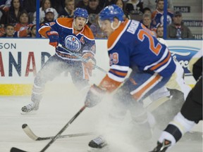 Taylor Hall of the Edmonton Oilers, tries to centre a pass to Leon Draisaitl  against the Pittsburgh Penguins at Rexall Place in Edmonton.