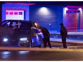 Edmonton police have a section of residential road in the south Edmonton community of Windermere blocked off Friday to investigate a crime scene involving a parked Audi.  Shaughn Butts/Edmonton Journal