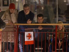 People take part in a vigil Nov. 16, 2015 at Edmonton's La Cite francophone for the victims of the attacks in Paris and around the world.
