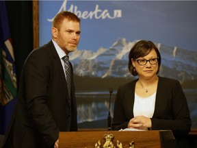 Environment Minister Shannon Phillips, right, announced June 25, 2015 that the Alberta government will boost the province's existing carbon levy on large industrial emitters starting in 2016. Phillips also announced that University of Alberta economist Andrew Leach, left, will chair a comprehensive review of the province's climate change policy.