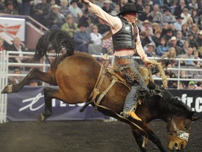 Jim Berry competes in the 2011 CFR saddle bronc contest.