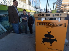 Owners Terry Wong, left, and Arden Tse, middle, stand with chef Jason Oliver in front of Prairie Noodle Shop, a soon-to-open ramen restaurant at 10350 124 St. in Edmonton on Tuesday.