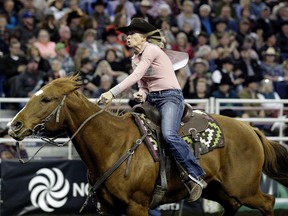 Nancy Csabay from Taber, Alberta competes in the Barrel Racing event at the 2015 Canadian Finals Rodeo.