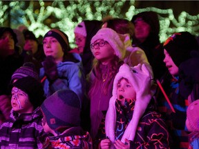 Children watch performers on the stage during the Holiday Light Up event at Churchill Square on Nov. 15, 2014, in Edmonton.