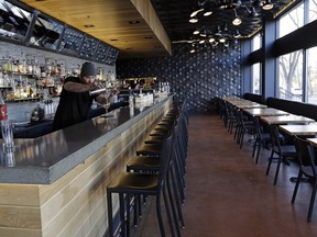 Tyler Gushaty, manager and head bartender at North 53 on 124th Street, pours a drink.