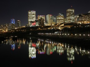The downtown Edmonton skyline is reflected on the North Saskatchewan River.