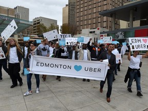 Uber supporters march last September at City Hall to support the company.