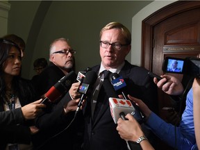 In this Sept. 23, 2015 file photo, Education Minister David Eggen speaks to media after meeting with members of the Catholic School Board at the legislature in Edmonton.