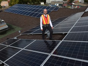 Clifton Lofthaug, owner of Great Canadian Solar Ltd., displays the new solar panels on the roof of the Devon Community Centre in Devon on Sept. 9, 2015.