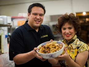 From left, Miles Quon and his mom, Amy Quon, from The Lingnan restaurant make a sticky rice stuffing for turkey that's a family favourite.