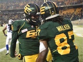 Edmonton Eskimos Derel Walker (87) celebrates with quarterback Mike Reilly (13) after his touchdown against Montreal Alouettes during CFL action at Commonwealth Stadium in Edmonton, Nov. 1, 2015.