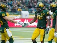 Nate Coehoorn, left, and Derel Walker celebrate a touchdown by Walker during the Edmonton Eskimos' final regular-season game against the Montreal Alouettes at Commonwealth Stadium on Nov. 1, 2015.  The Eskimos won 40-22.