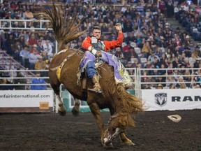 Caleb Bennett stays atop Starburst to win the bareback riding event on opening night of the Canadian Finals Rodeo at Rexall Place in Edmonton on Wednesday, Nov. 11, 2015.