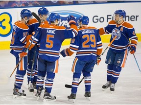 Edmonton Oilers Teddy Purcell (16), Oscar Klefbom (77), Mark Fayne (5), Leon Draisaitl (29), and Taylor Hall (4) celebrate Klefbom's goal on New Jersey Devils goalie Keith Kinkaid (1) during NHL action at Rexall Place in Edmonton on Nov.20, 2015.